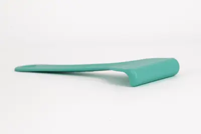 Espátula Meduclean de color azul marino con la parte de rascar apoyada en el suelo.